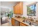 Bright kitchen showcasing granite countertops, light wood cabinetry, a double basin sink, and an adjacent breakfast area at 219 W Columbia Pl, Chapel Hill, NC 27516