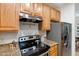Modern kitchen with light wood cabinetry, granite counters, stainless steel range hood and stainless steel refrigerator at 219 W Columbia Pl, Chapel Hill, NC 27516