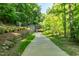 A scenic community path with landscaped features and access to a serene tunnel at 219 W Columbia Pl, Chapel Hill, NC 27516