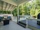 Inviting back deck with comfortable seating, a fire pit, and scenic views of the surrounding trees at 221 Stella Way, Cameron, NC 28326
