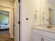 Bright bathroom features modern sink, a mirror, and a view into an adjacent bedroom at 221 Stella Way, Cameron, NC 28326