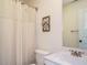 Bright bathroom with a vanity, toilet, shower with curtain, and decorative wreath on the wall at 221 Stella Way, Cameron, NC 28326