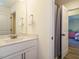 Modern bathroom with marble countertops, framed mirror, and an open door leading to the bedroom at 221 Stella Way, Cameron, NC 28326