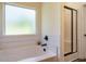 Bright bathroom features a soaking tub, subway tile backsplash, and a glass-enclosed shower at 221 Stella Way, Cameron, NC 28326