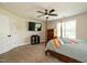 Comfortable bedroom featuring a ceiling fan, four-poster bed, and window with ample natural light at 221 Stella Way, Cameron, NC 28326