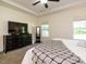 Bedroom features a tray ceiling, large dresser, and view to the outside at 221 Stella Way, Cameron, NC 28326