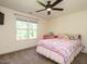 Charming bedroom with a bed, dresser, ceiling fan and a window providing ample natural light at 221 Stella Way, Cameron, NC 28326