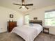 Cozy bedroom with comfortable bed, ceiling fan, dresser, and natural light from two windows at 221 Stella Way, Cameron, NC 28326