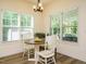 Sunlit breakfast nook features a round table, white chairs, and views of the outdoors at 221 Stella Way, Cameron, NC 28326