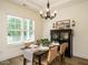 Inviting dining area features a modern chandelier and a beautiful china cabinet perfect for entertaining at 221 Stella Way, Cameron, NC 28326
