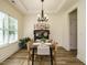 Inviting dining area features a modern chandelier, tray ceilings and large windows for natural light at 221 Stella Way, Cameron, NC 28326