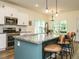 Gourmet kitchen with granite countertops, stainless appliances, and a spacious island with barstool seating at 221 Stella Way, Cameron, NC 28326