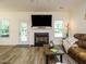 Open living room features a fireplace, TV, and access to the outdoor space at 221 Stella Way, Cameron, NC 28326