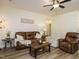 Comfortable living room with a leather sofa, armchairs, and a rustic coffee table at 221 Stella Way, Cameron, NC 28326