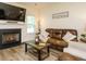 Inviting living room with a fireplace, leather sofa, and a rustic coffee table at 221 Stella Way, Cameron, NC 28326