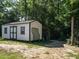 Exterior view of the white outbuilding, featuring black trim and double doors at 221 Stella Way, Cameron, NC 28326