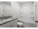 Bathroom boasts granite countertops, white cabinets, and a shower-tub combo at 224 Ivy Bank Dr, Angier, NC 27501