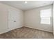 Neutral bedroom featuring a double door closet and a large window offering plenty of natural light at 224 Ivy Bank Dr, Angier, NC 27501