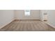 Spacious bedroom with neutral paint and carpet. A window provides natural light at 224 Ivy Bank Dr, Angier, NC 27501