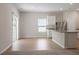 Bright dining area with sliding glass doors and wood flooring, next to modern kitchen at 224 Ivy Bank Dr, Angier, NC 27501