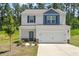 Charming two-story home with a two-car garage, stone accents, and a well-manicured lawn at 224 Ivy Bank Dr, Angier, NC 27501