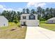 View of a charming two-story home with a two-car garage and landscaped front yard at 224 Ivy Bank Dr, Angier, NC 27501