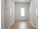 Bright hallway featuring wood floors and multiple doors, leading to various rooms at 224 Ivy Bank Dr, Angier, NC 27501