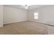 Open-concept living space with neutral tones, ceiling fan, and lots of natural light at 224 Ivy Bank Dr, Angier, NC 27501