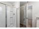 Bright shower with white tile. Open door leads to bedroom with carpet flooring at 224 Ivy Bank Dr, Angier, NC 27501