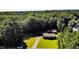 An aerial view of the home with a large yard and driveway surrounded by trees at 233 Pressly Foushee Rd, Sanford, NC 27330