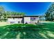 Exterior of a home highlighting the spacious backyard and screened-in porch at 233 Pressly Foushee Rd, Sanford, NC 27330