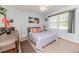 Bedroom showcasing neutral paint, a plush bed, and a dark wood dresser at 233 Pressly Foushee Rd, Sanford, NC 27330