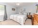 Bright bedroom featuring soft carpet, a cozy bed, and a wooden dresser at 233 Pressly Foushee Rd, Sanford, NC 27330