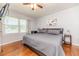 Cozy bedroom features a plush grey bed, bright natural light, and wood flooring at 233 Pressly Foushee Rd, Sanford, NC 27330
