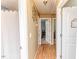Hallway with wood flooring, white trim, and doorways leading to various rooms at 233 Pressly Foushee Rd, Sanford, NC 27330