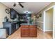 Spacious kitchen featuring an island, dark cabinets, granite countertops, and modern appliances for cooking and entertaining at 233 Pressly Foushee Rd, Sanford, NC 27330
