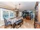 Open-concept dining and kitchen area with wood floors and access to a sunroom at 233 Pressly Foushee Rd, Sanford, NC 27330