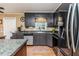 Well-lit kitchen with dark cabinets, stainless steel appliances, and an island, offering ample counter space at 233 Pressly Foushee Rd, Sanford, NC 27330