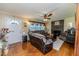 Cozy living room featuring hardwood floors, a brick fireplace, comfortable seating, and lots of natural light at 233 Pressly Foushee Rd, Sanford, NC 27330