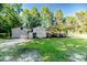 The property features multiple outbuildings and a covered shelter for boat or vehicle storage at 233 Pressly Foushee Rd, Sanford, NC 27330