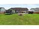 Large backyard with a firepit and trampoline offers plenty of space for outdoor activities at 236 Emma Ct, Linden, NC 28356