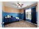 Bedroom with a ceiling fan, neutral carpet, large window, and blue and tan color scheme at 236 Emma Ct, Linden, NC 28356