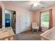 Pink Bedroom with closet, blinds on the window, neutral carpet, and a crib at 236 Emma Ct, Linden, NC 28356