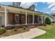 Inviting front porch with classic columns, brick accents, and comfortable seating at 236 Emma Ct, Linden, NC 28356