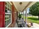 Covered front porch featuring classic columns, comfortable seating, and a welcoming ambiance at 236 Emma Ct, Linden, NC 28356