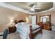 This main bedroom features a tray ceiling with ceiling fan, carpeted floor, and beautiful furniture at 236 Emma Ct, Linden, NC 28356