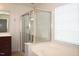 Bright bathroom featuring shower with glass door and separate garden tub next to a large window at 2507 Princewood St, Raleigh, NC 27612