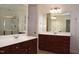 Double vanities in a spacious bathroom with mirrors and storage underneath at 2507 Princewood St, Raleigh, NC 27612