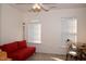 Bright bedroom features neutral carpet, a large window, and a red sofa at 2507 Princewood St, Raleigh, NC 27612