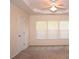 Bright bedroom featuring neutral walls, plush carpet, and a ceiling fan with ample natural light from three windows at 2507 Princewood St, Raleigh, NC 27612